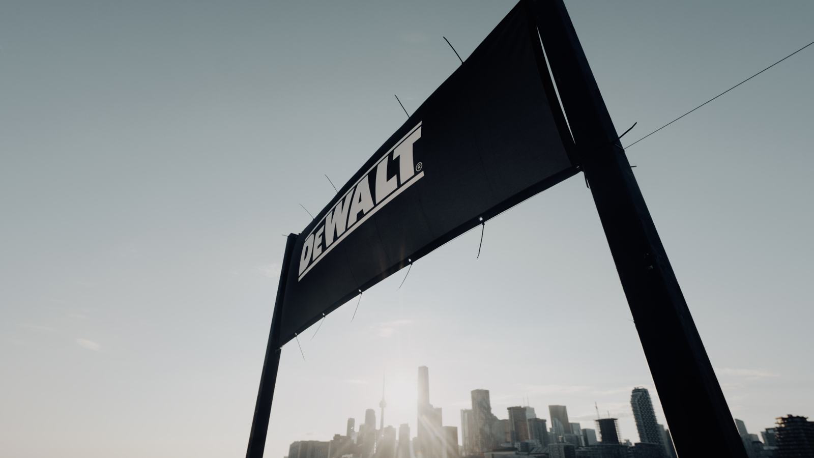 DEWALT banner backlit by the sun over the skyline