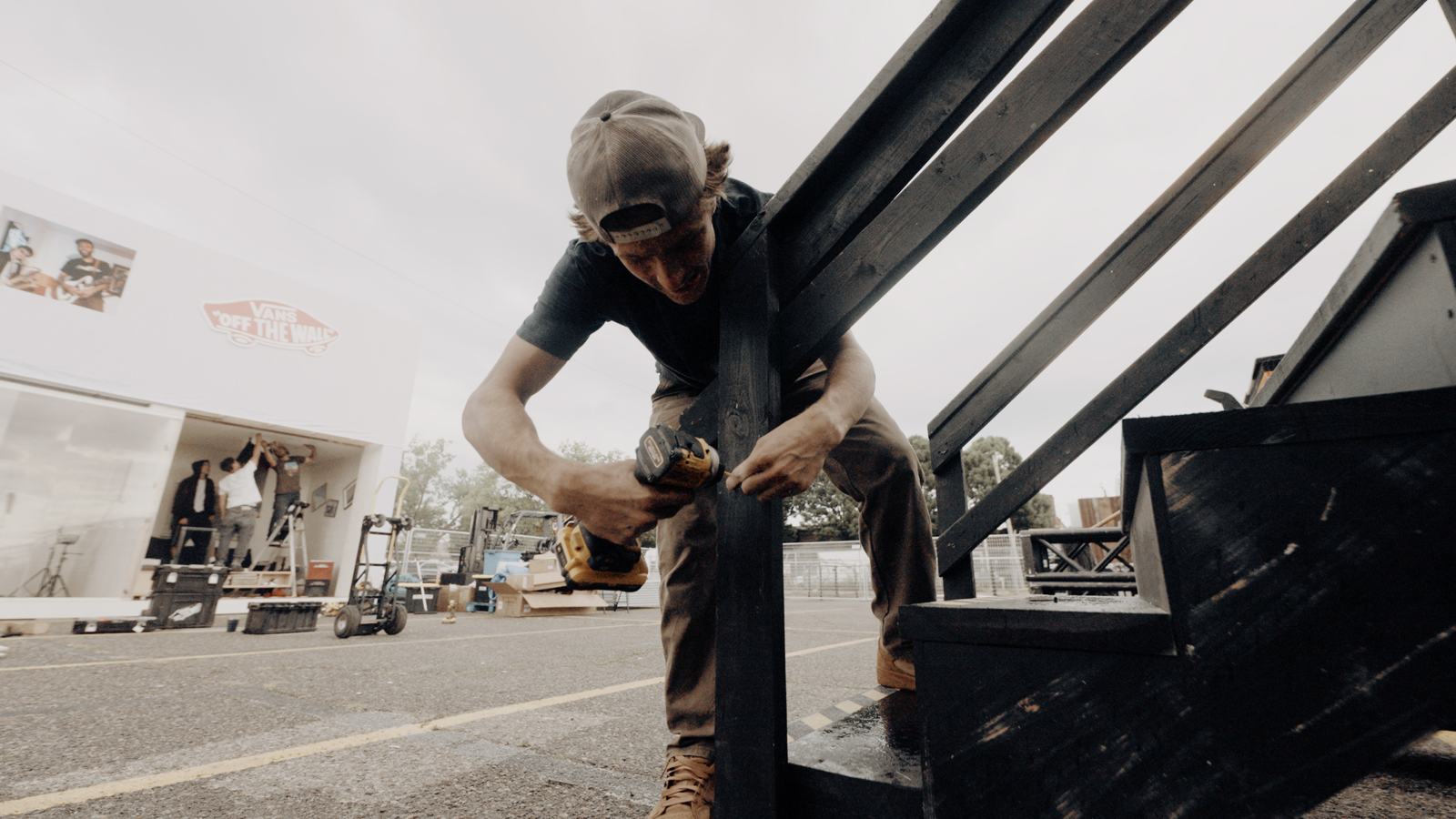 Builder driving screws into a stair set with a DEWALT impact driver