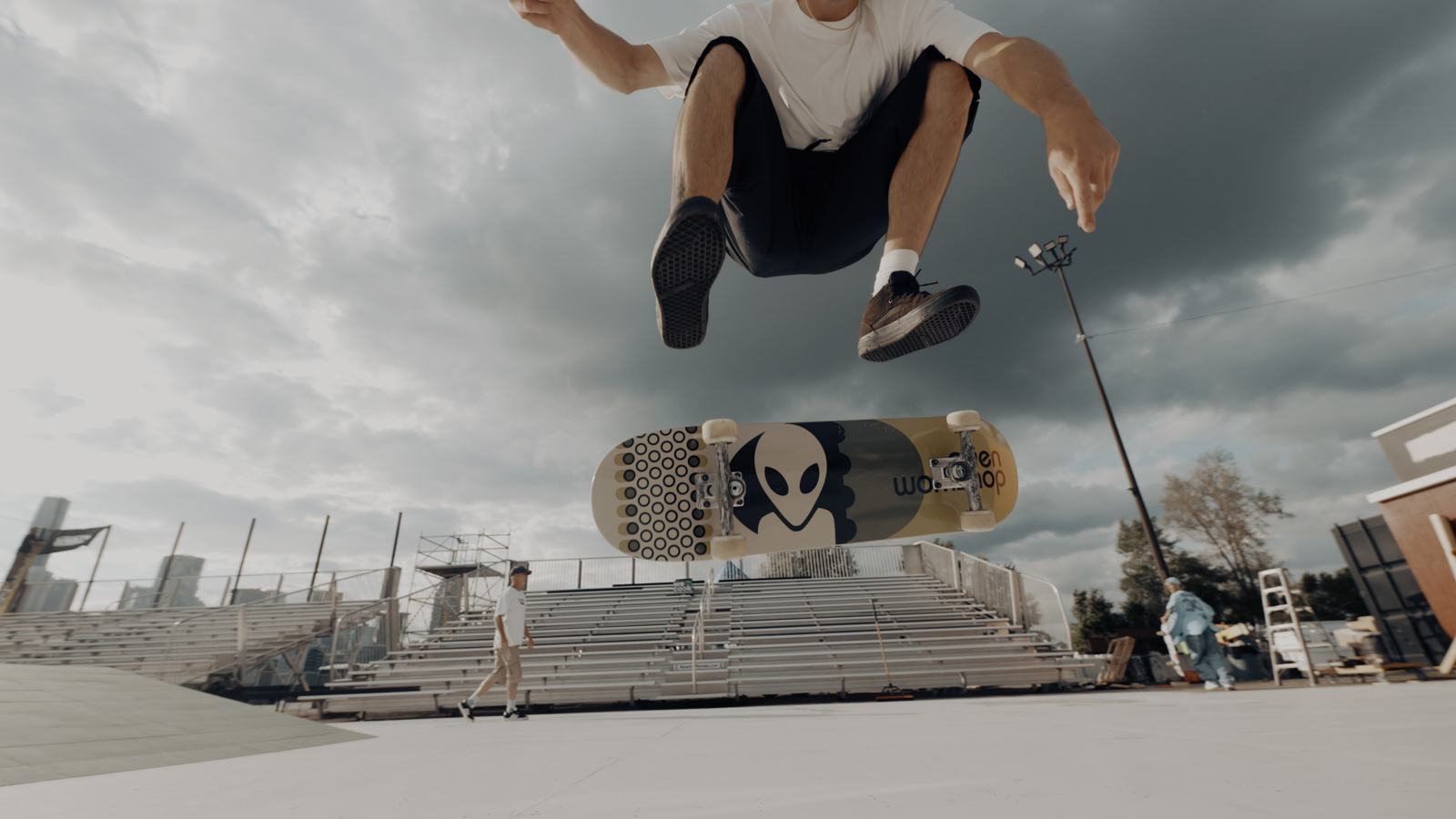 Kickflip shot from below, board spinning under the skater