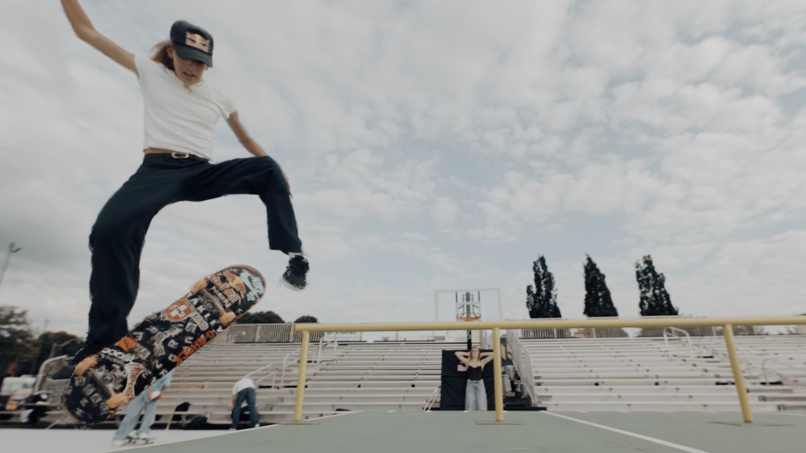 Skater in a Red Bull cap popping an ollie